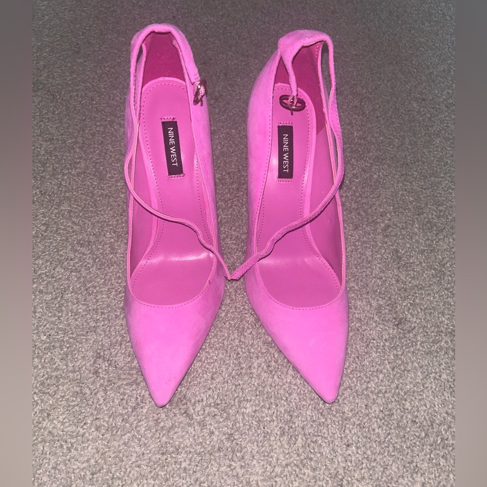 Bubblegum pink suede pointy toed heels with ankle strap.